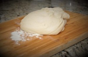 Bread dough on a floured surface.