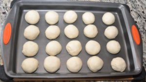 Pav dinner rolls balls in a tray.