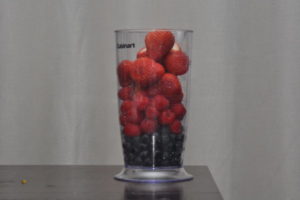 Strawberry Blueberry Raspberry in a container.
