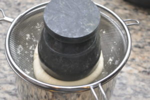 paneer with weight to make firm.