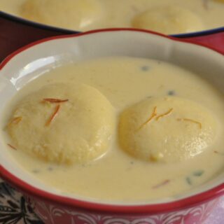 2 pieces of Rasmalai served in a bowl.