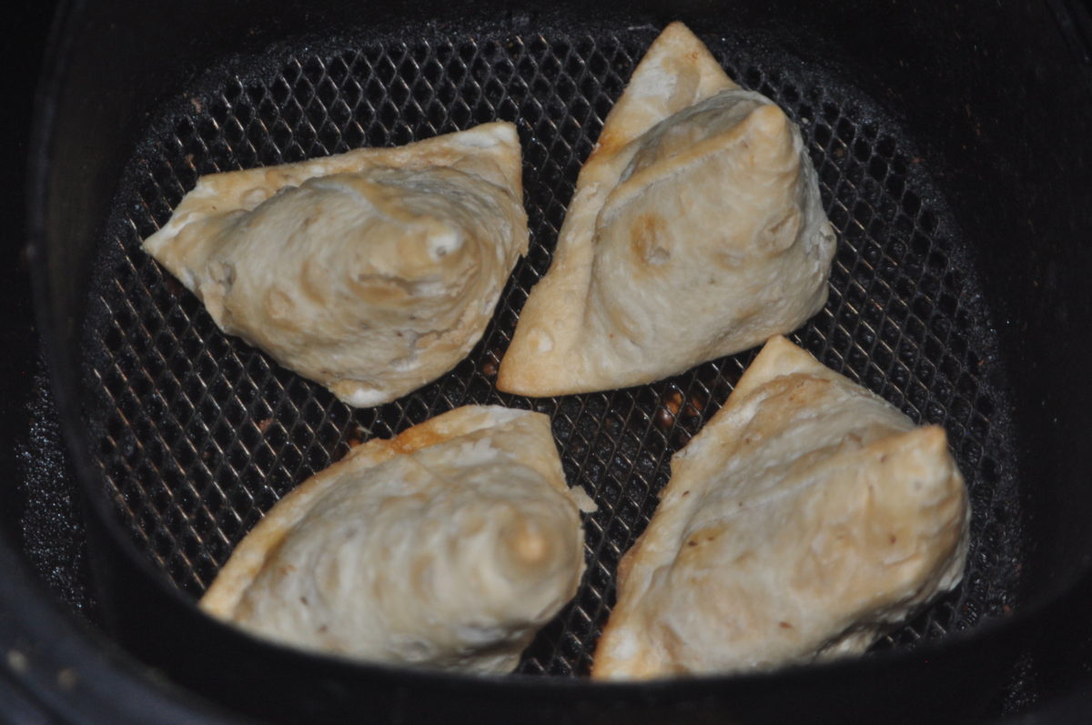 4 Frozen Samosa in air fryer for cooking.