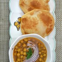 Chhole bhature served in a platter.
