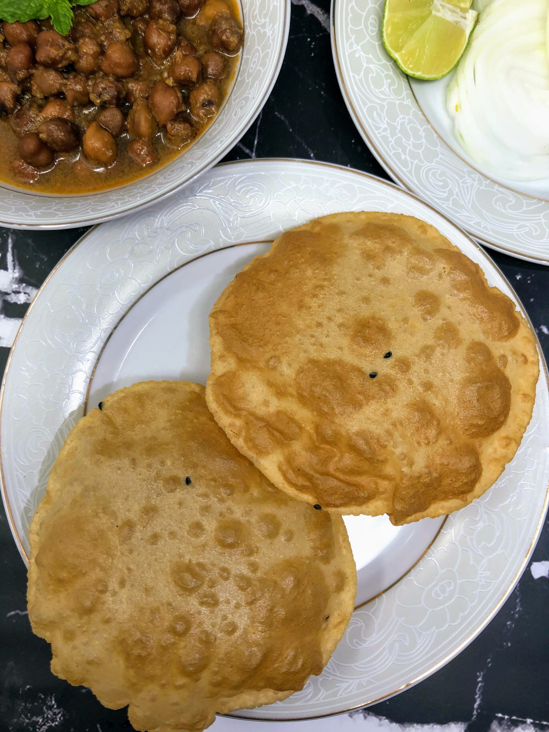 Two Deep fried puri or Indian puffy bread served in a plate