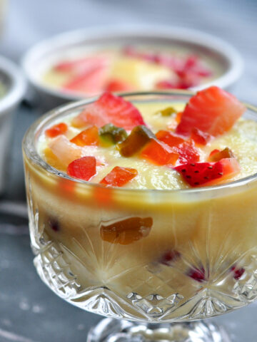 indian custard in a bowl with fruits.