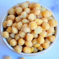 Close up view of boiled chickpeas in a bowl.