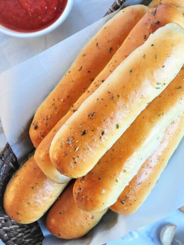 stacked baked bread sticks.