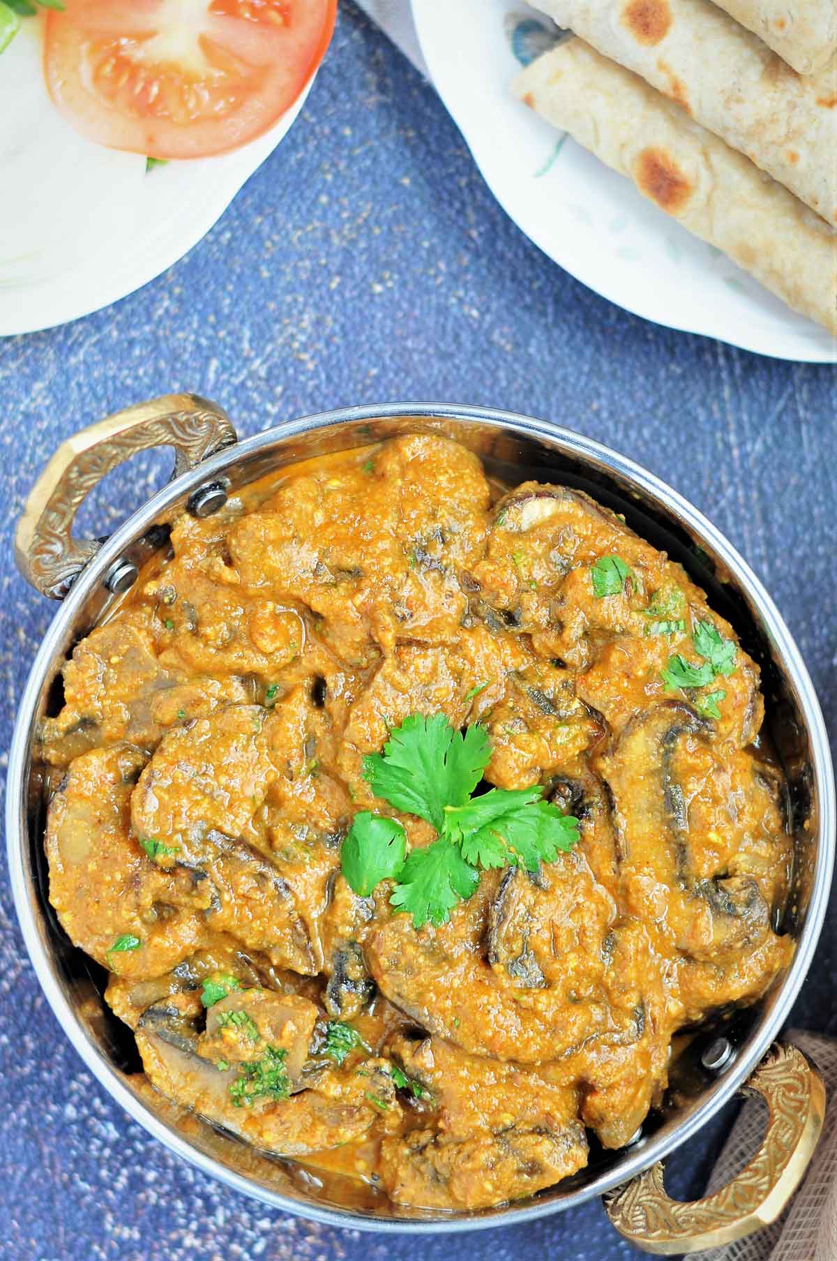Mushroom masala curry served in a serving wok.
