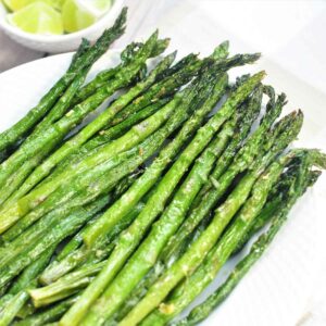 Air fried frozen asparagus served in a plate.