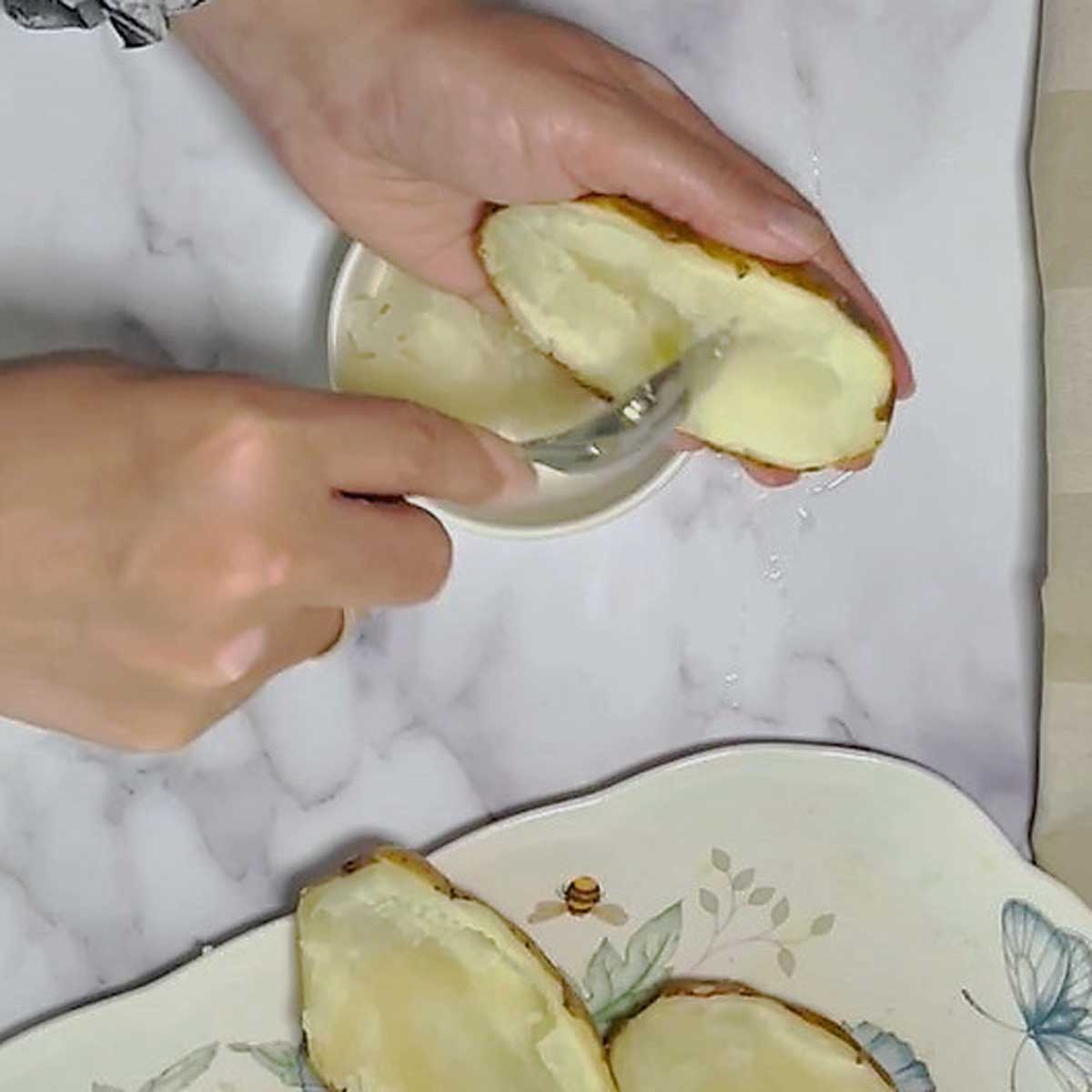 Scrape potato halves with a spoon.