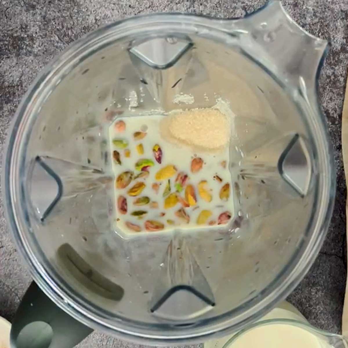 Pistachio ice cream ingredients in a blender.