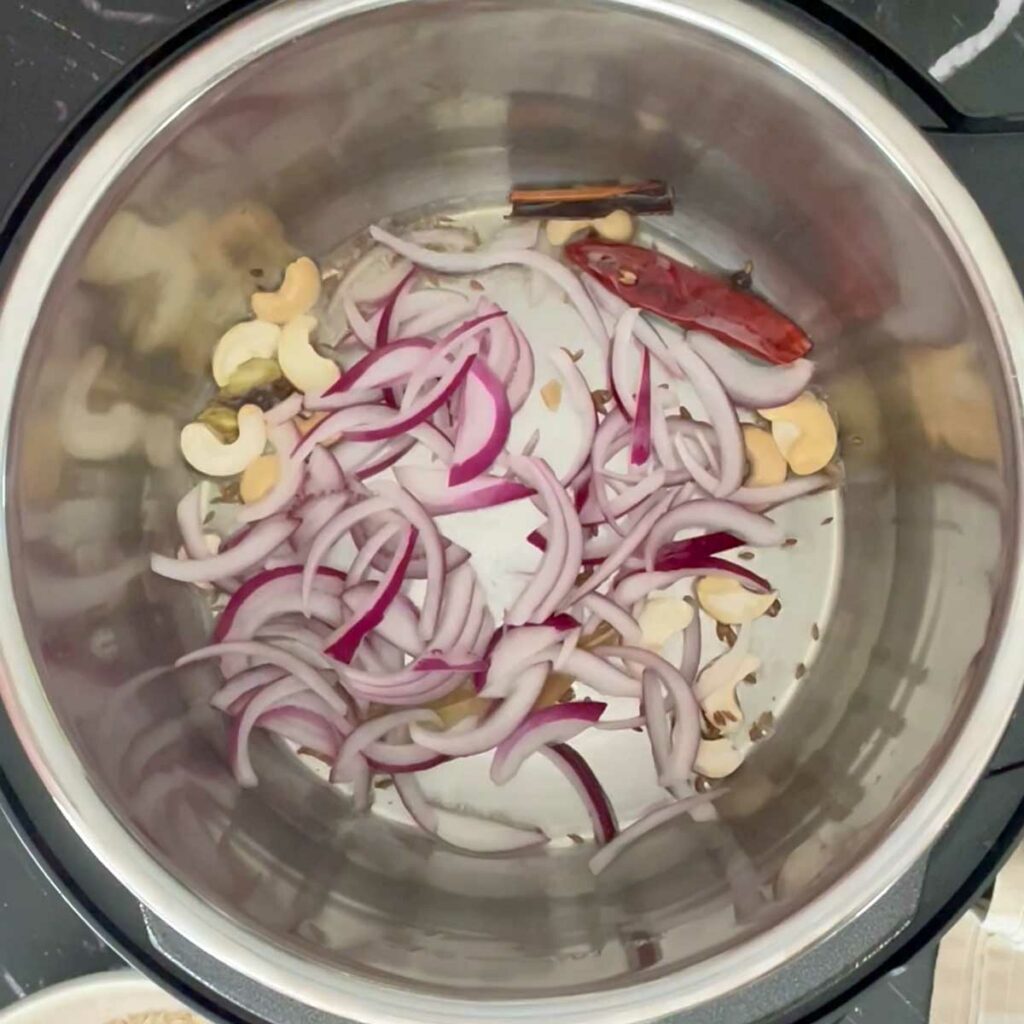 Saute onion for mushroom pilao in instant pot.
