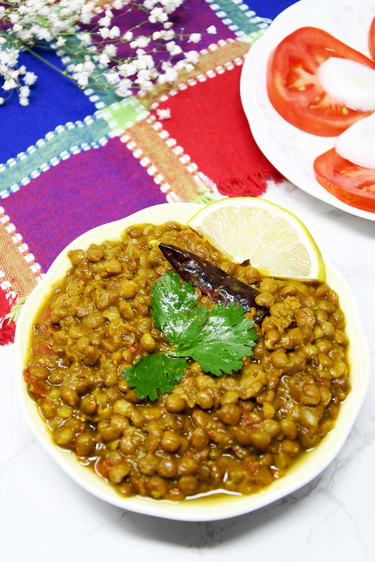 Whole Masoor Dal curry in a serving bowl.