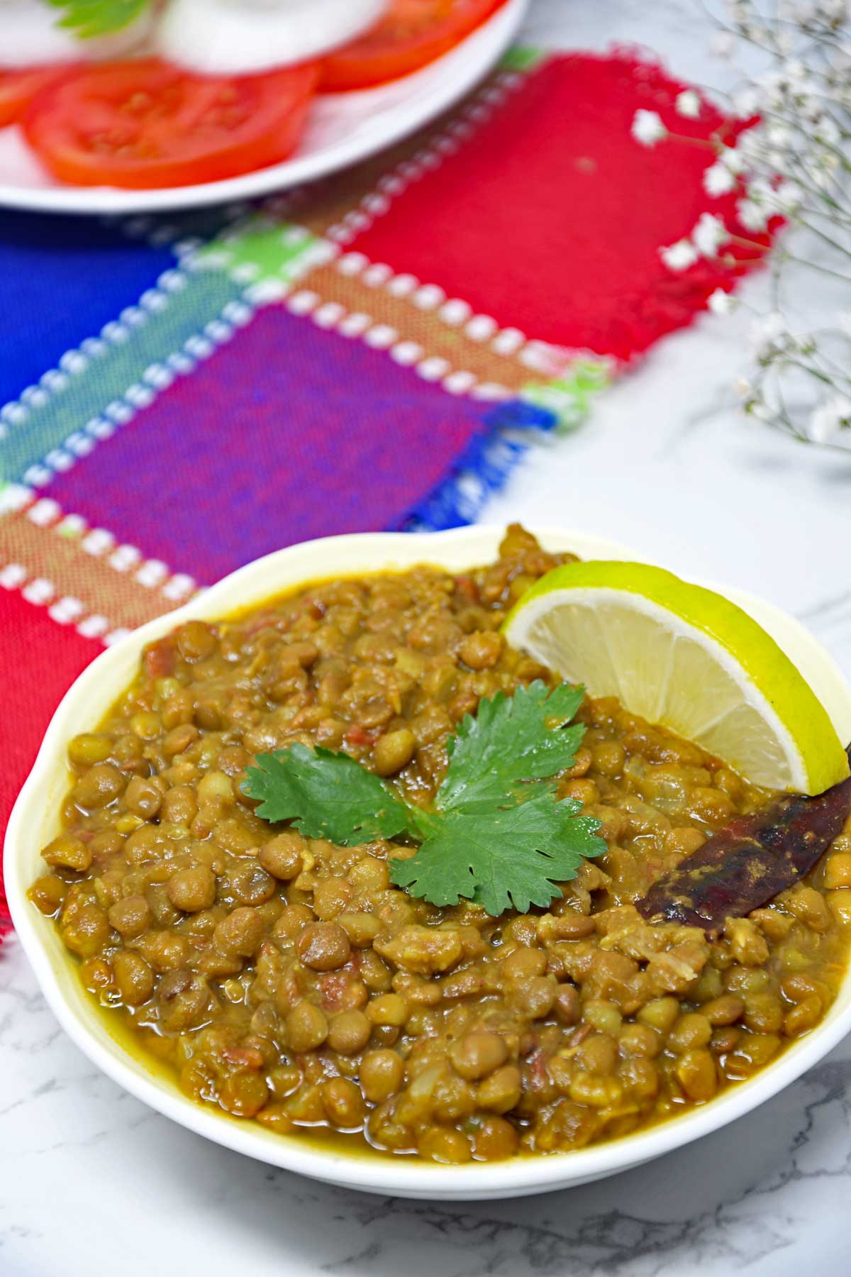 Whole Masoor Dal curry in a serving bowl.
