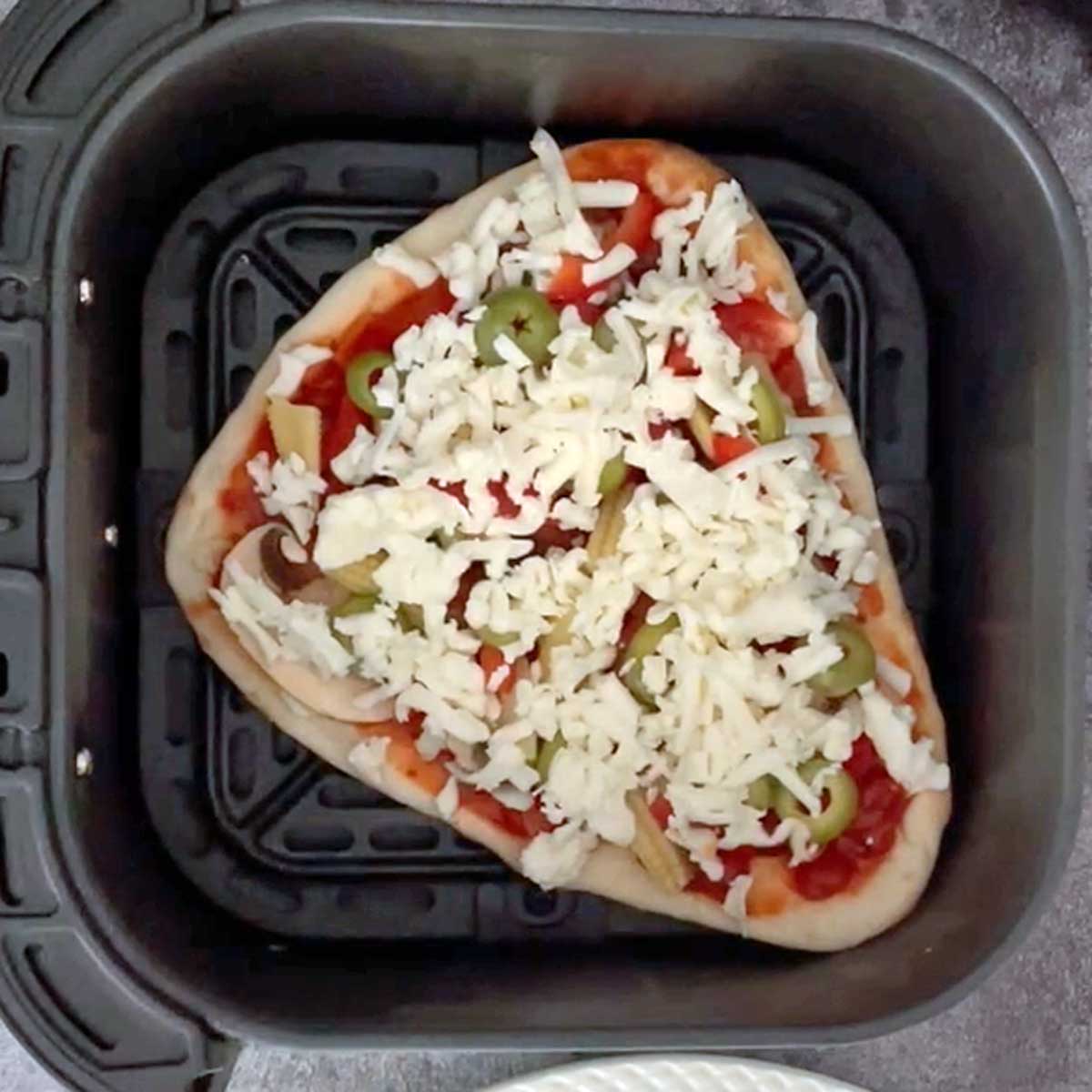 Naan Pizza placed in fryer tub.