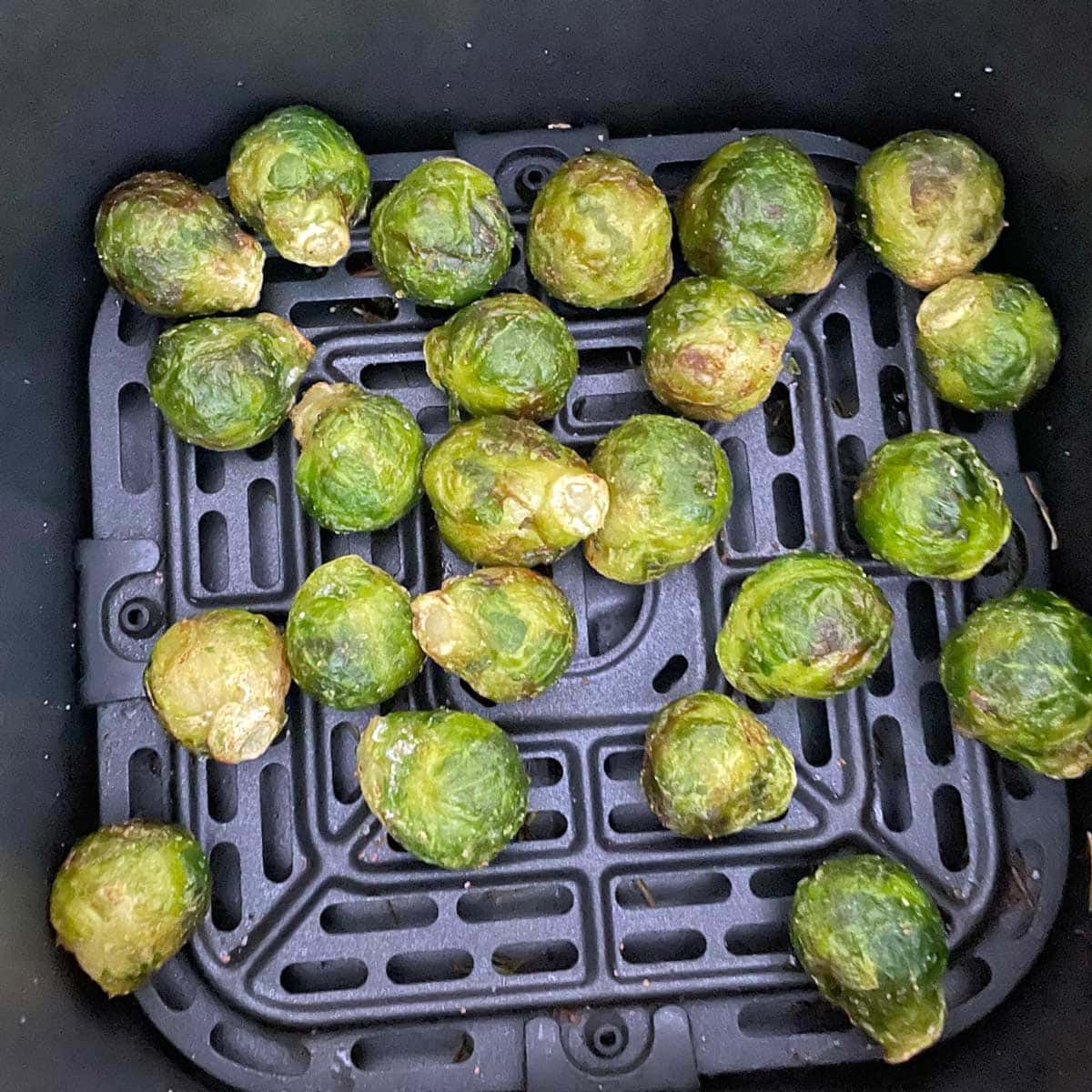 Air fryer frozen Brussels sprouts cooked in fryer.