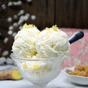 Ginger ice cream scoops in a glass bowl.
