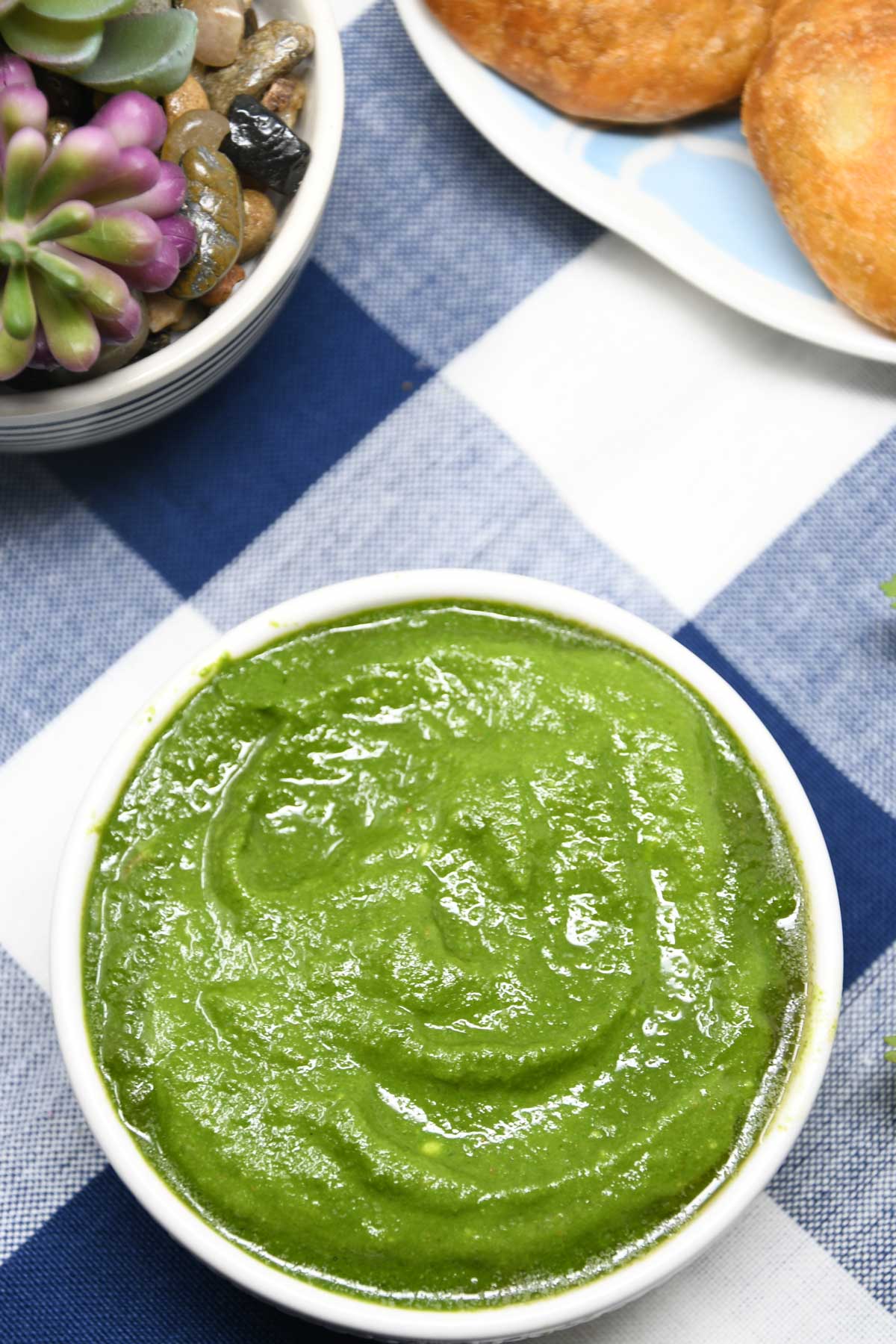 Green cilantro chutney served in a bowl.