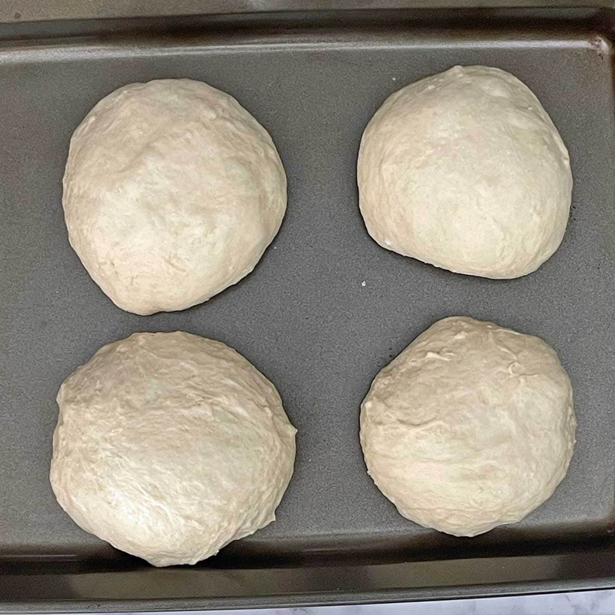 Sub-divided Pizza dough in a tray.