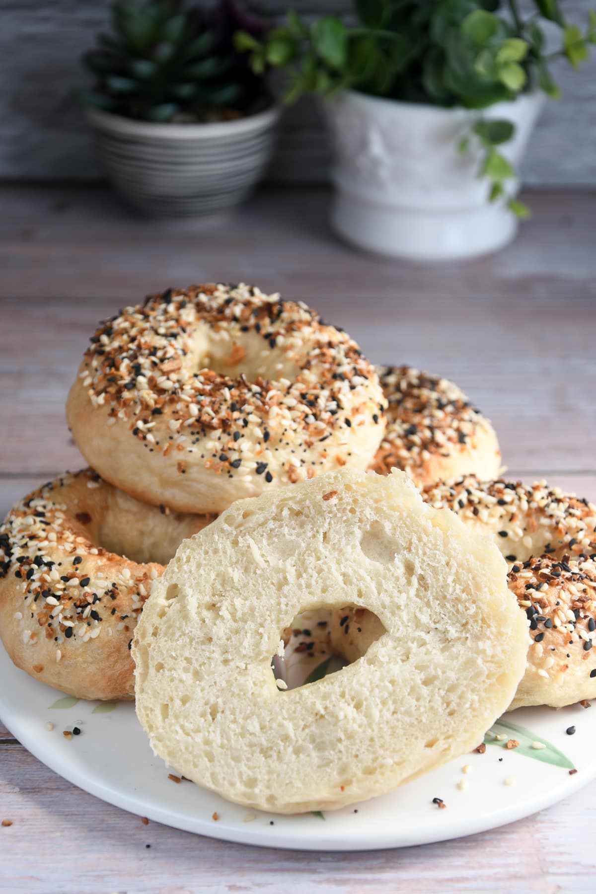Bread machine bagels stacked on a serving plate.