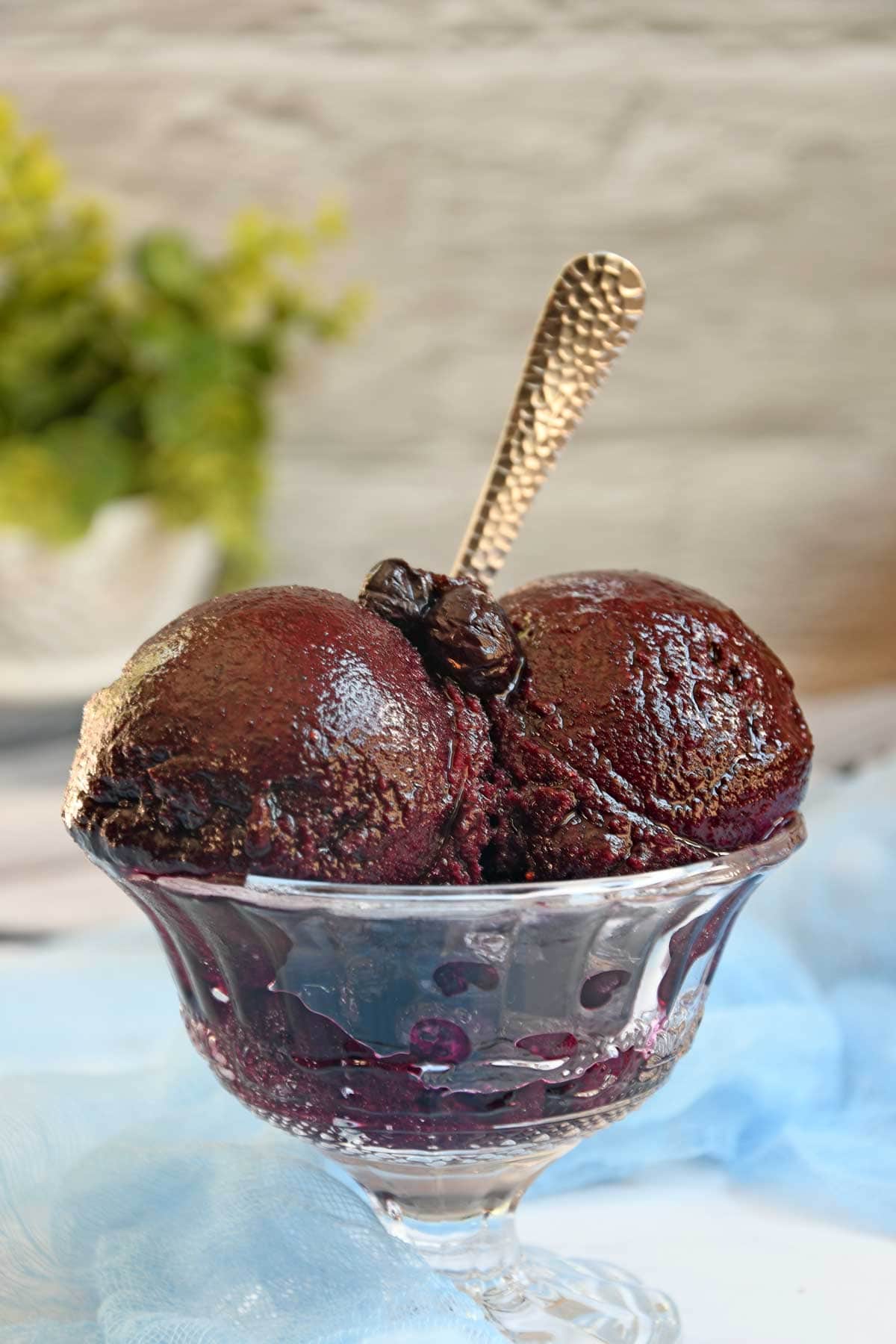 Blueberry Sorbet scoops in a glass bowl.