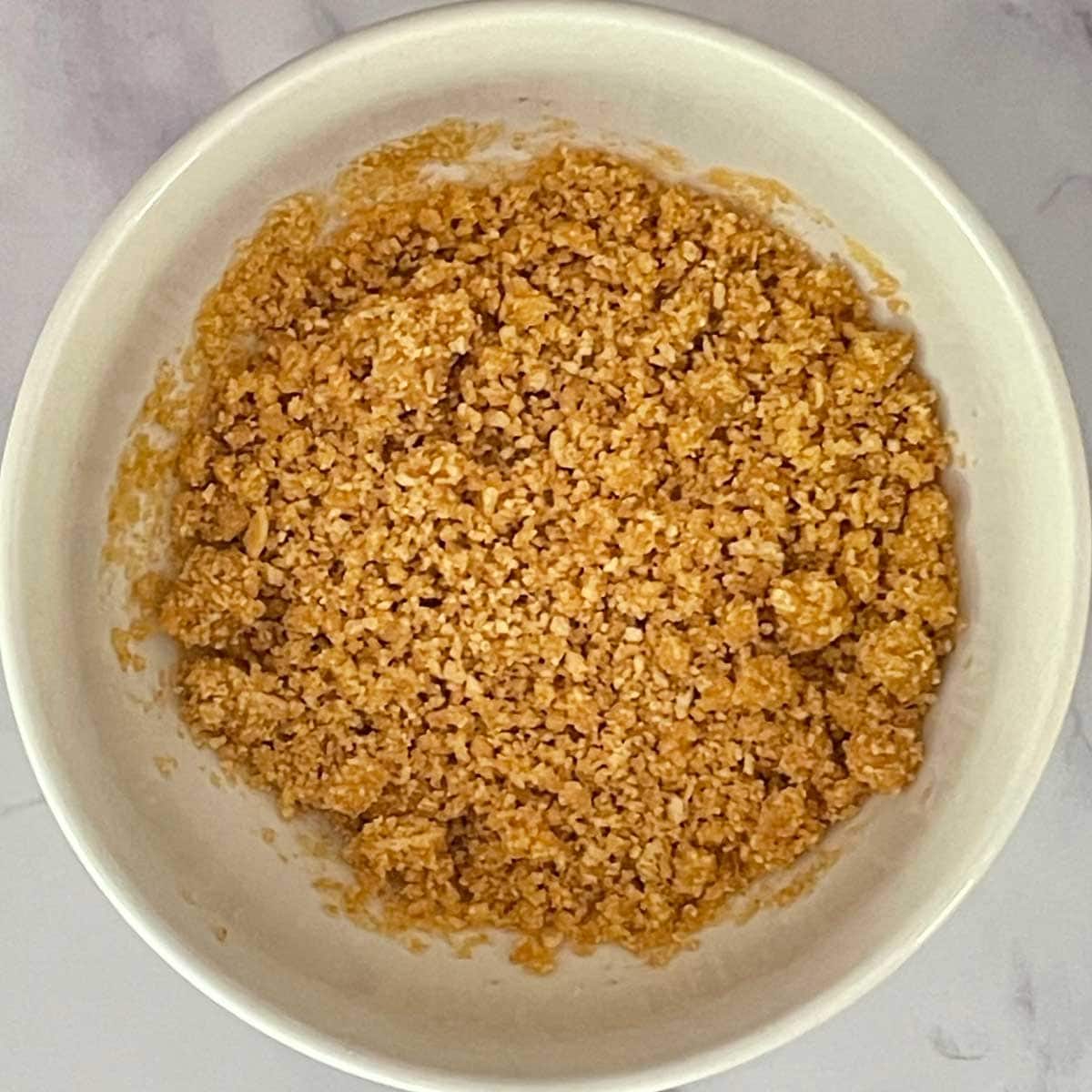 Crushed Graham's cracker in a bowl.