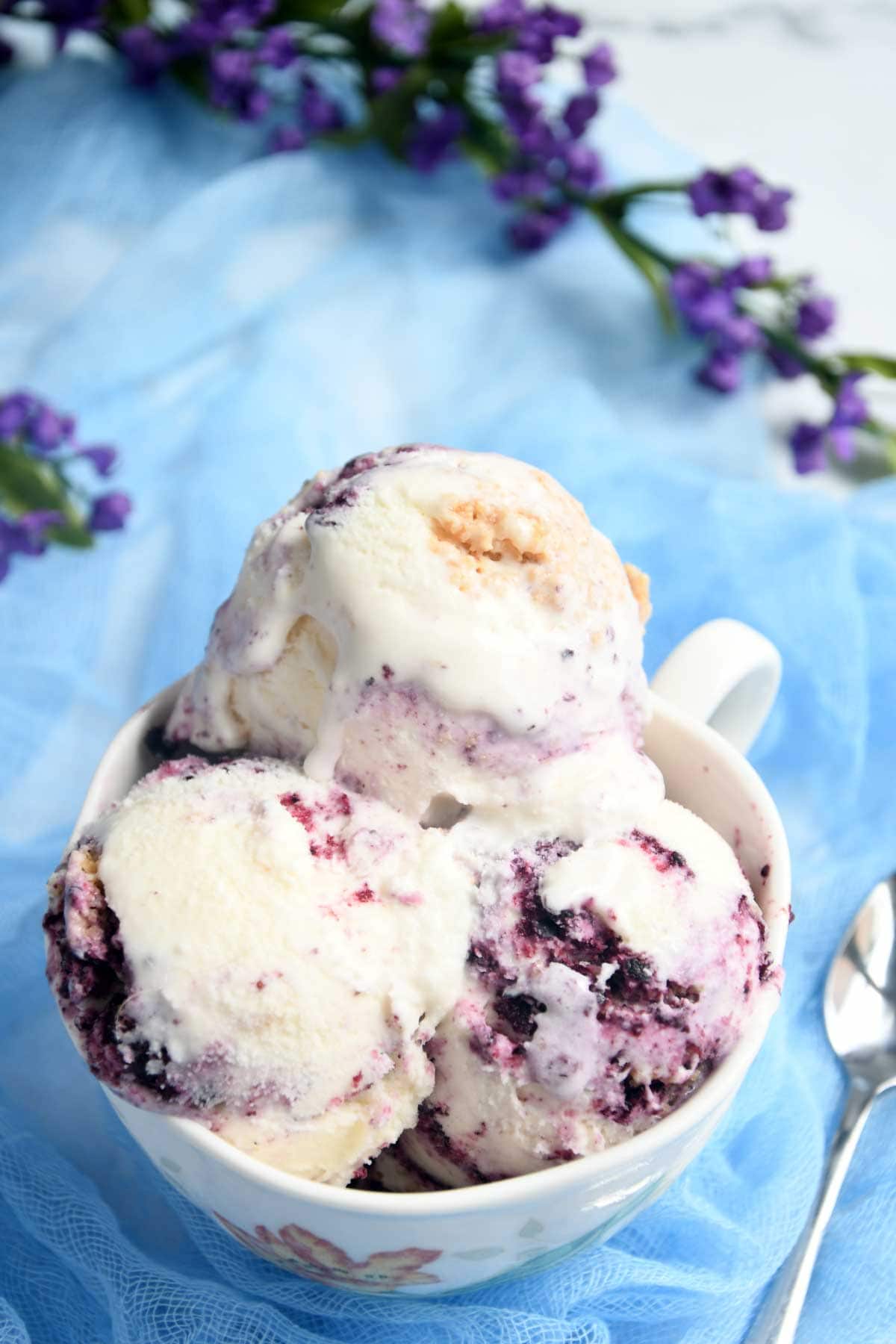 Blueberry cheesecake ice-cream scoops in a bowl.