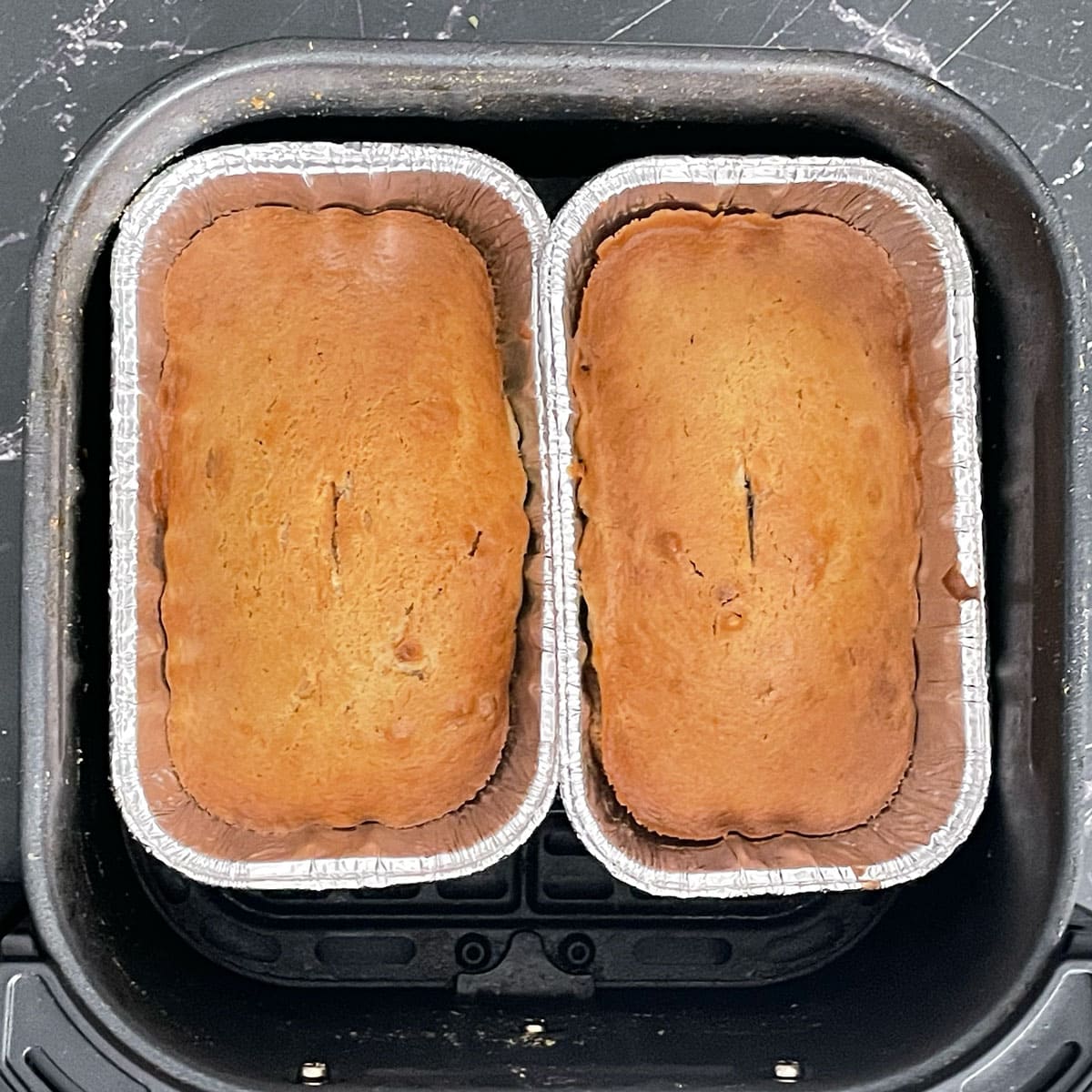 Baked banana bread in loaf pans.