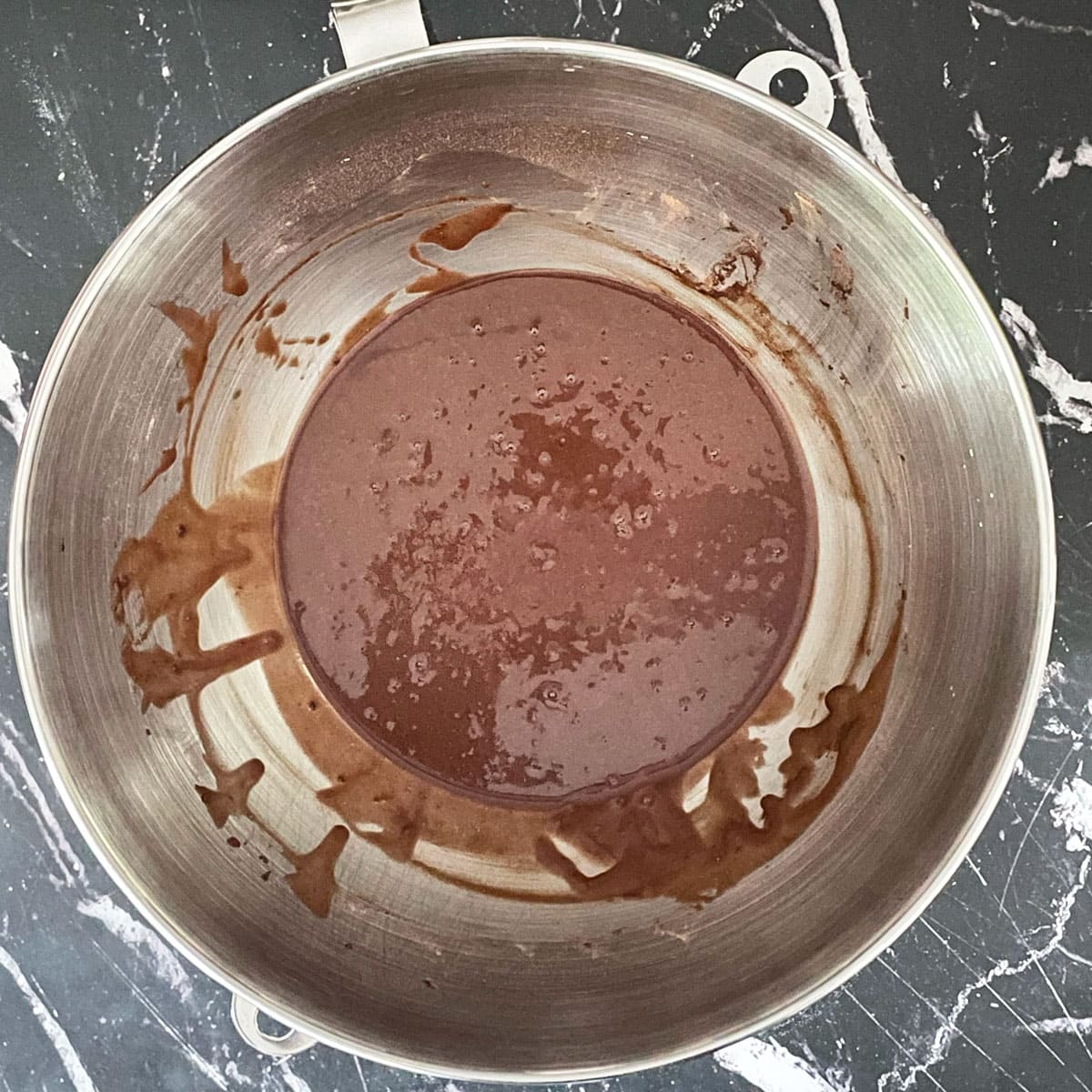 Chocolate cake batter in mixer bowl.