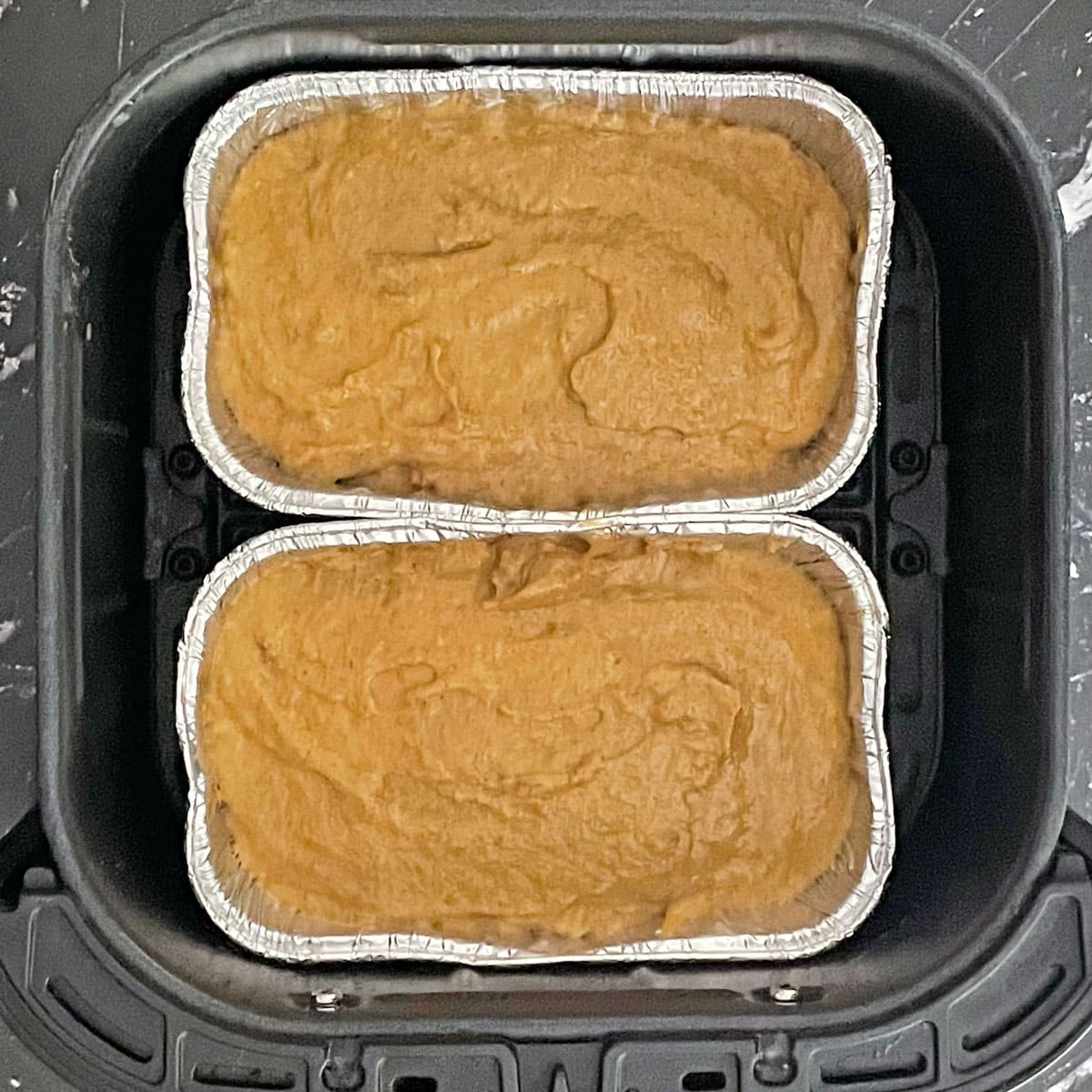 Air pumpkin bread batter in loaf pan.