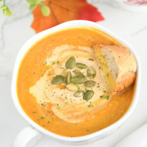 Pumpkin carrot soup in soup bowls.