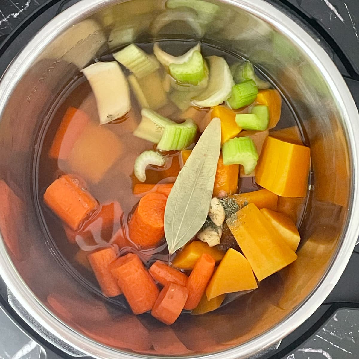 Butternut squash chopped ingredients in Instant pot liner.
