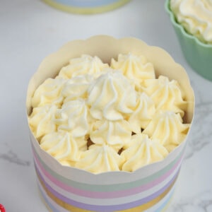 Butter cream frosting topping on a vanilla cupcake.