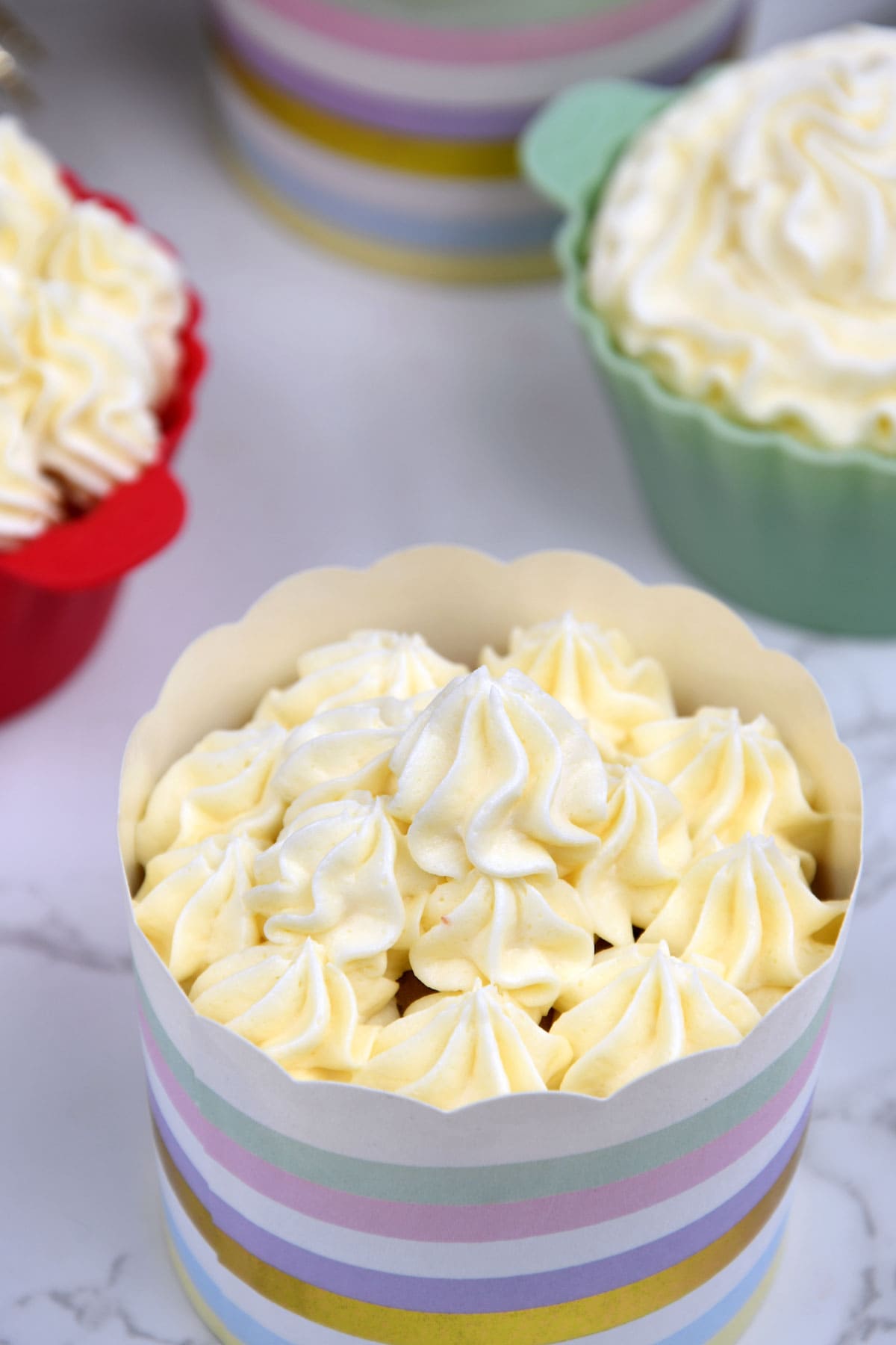 Butter cream frosting topping on a vanilla cupcake.