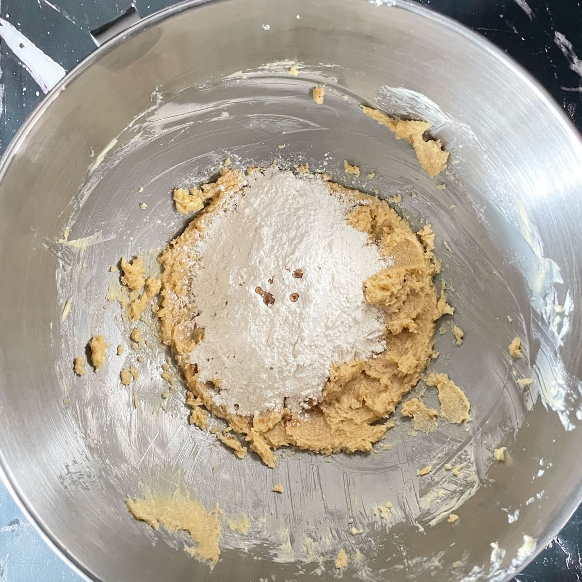 Fluffed butter and flour in a mixer bowl.
