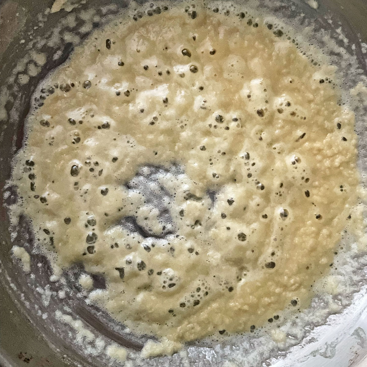 Making white pasta sauce in a pan.
