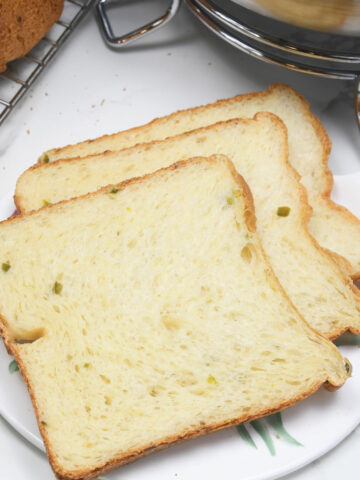 Jalapeno bread slices on a serving plate.