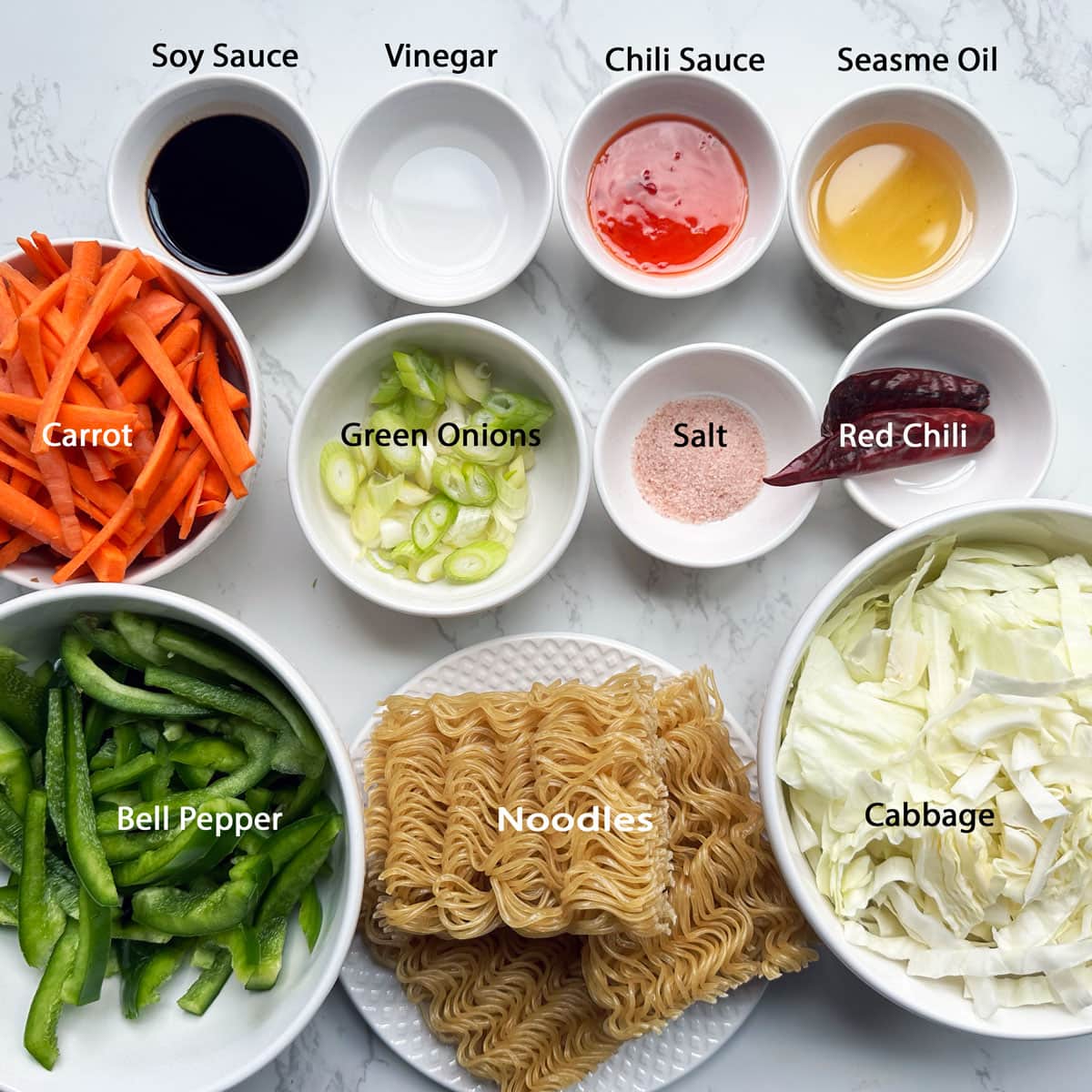 Hakka noodles ingredients in bowls.