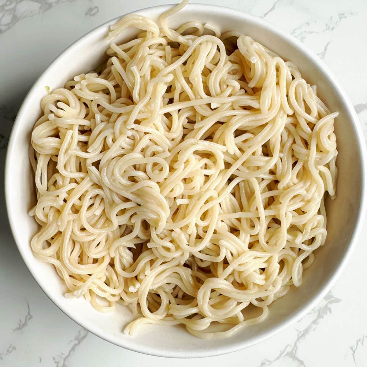 Boiled and strained noodles in a bowl.