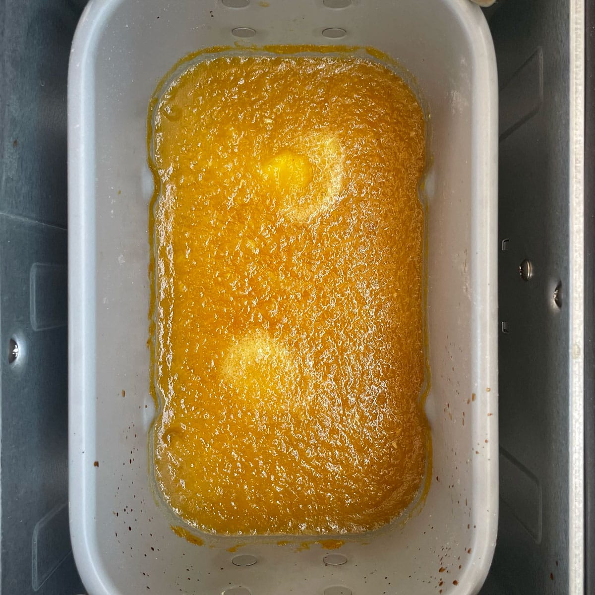 Pineapple jam in bread machine container.